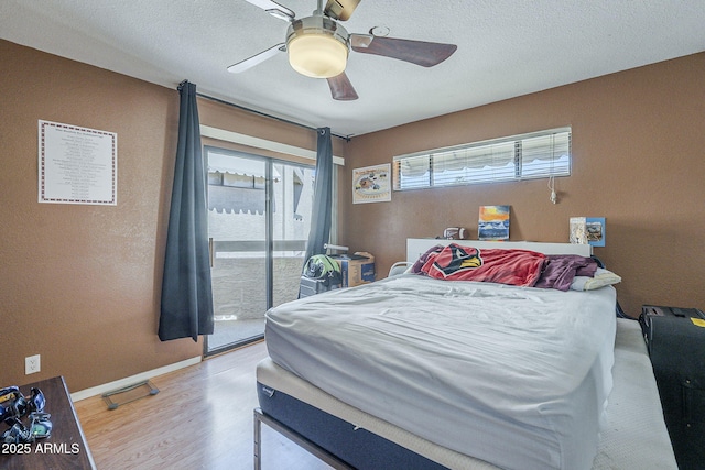 2228 N 52nd St Unit 213, Phoenix, AZ 85008 - bedroom with access to exterior, light wood-style flooring, baseboards, and a ceiling fan