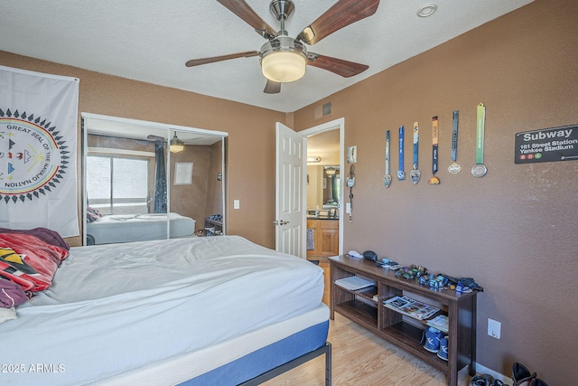2228 N 52nd St Unit 213, Phoenix, AZ 85008 - bedroom with wood finished floors and a ceiling fan