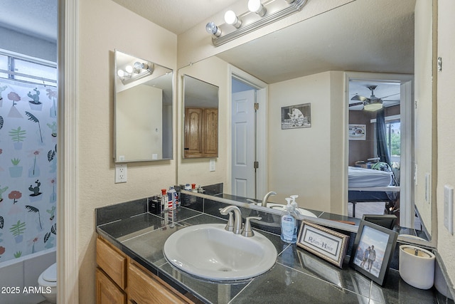 2228 N 52nd St Unit 213, Phoenix, AZ 85008 - full bathroom with vanity, shower / tub combo with curtain, ceiling fan, and toilet