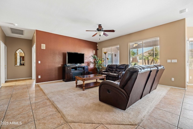 living room featuring visible vents, ceiling fan, and light tile patterned floors