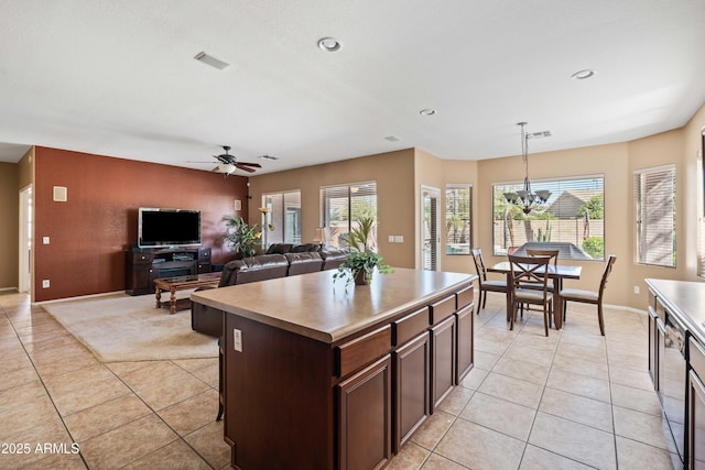 kitchen featuring light tile patterned floors, hanging light fixtures, and a wealth of natural light