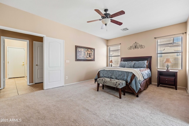 bedroom with light carpet, ceiling fan, visible vents, and multiple windows