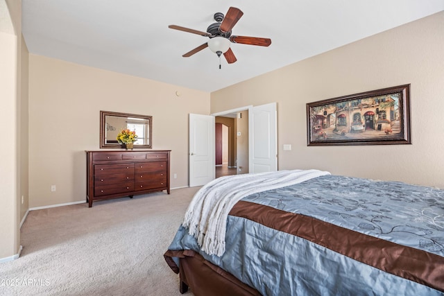 carpeted bedroom with baseboards and a ceiling fan