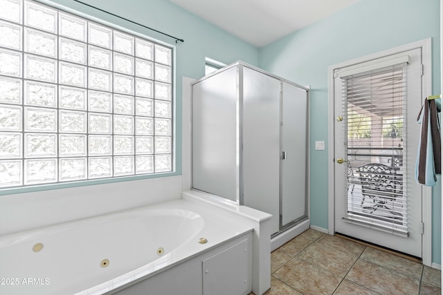 bathroom with a whirlpool tub, a stall shower, tile patterned flooring, and a healthy amount of sunlight