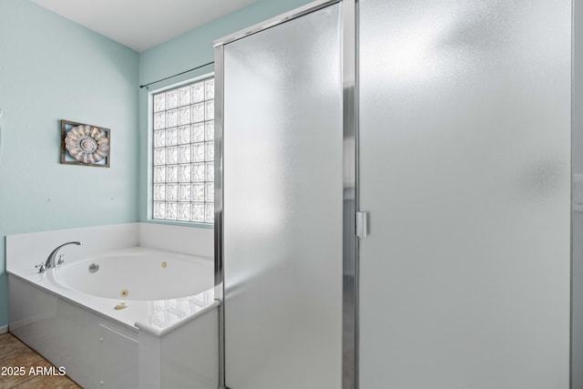 full bath with a jetted tub, plenty of natural light, and a stall shower