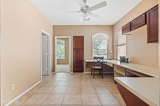 home office with a healthy amount of sunlight, light tile patterned floors, ceiling fan, and visible vents