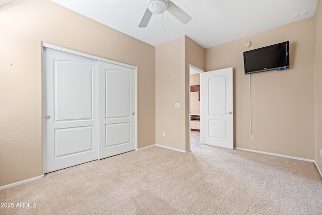 unfurnished bedroom featuring carpet floors, a closet, and baseboards