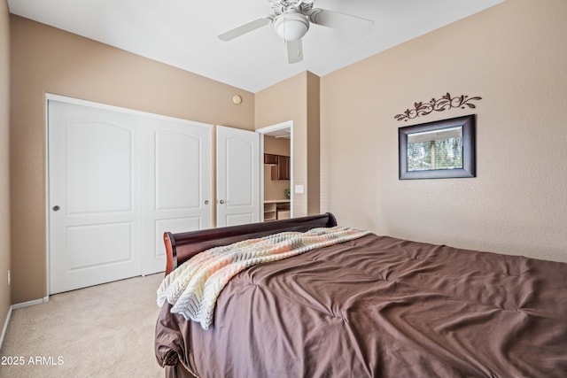 bedroom featuring ceiling fan, a closet, and light colored carpet