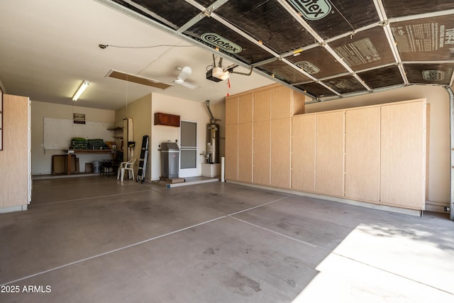 garage featuring a garage door opener and water heater