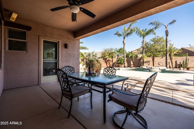 view of patio with ceiling fan, outdoor dining area, a fenced backyard, and a pool with connected hot tub