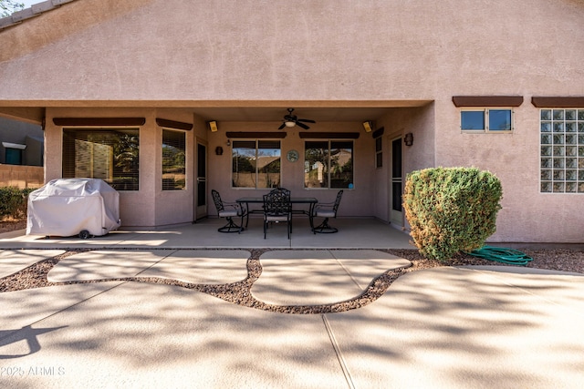 view of patio / terrace with outdoor dining space, a grill, and a ceiling fan