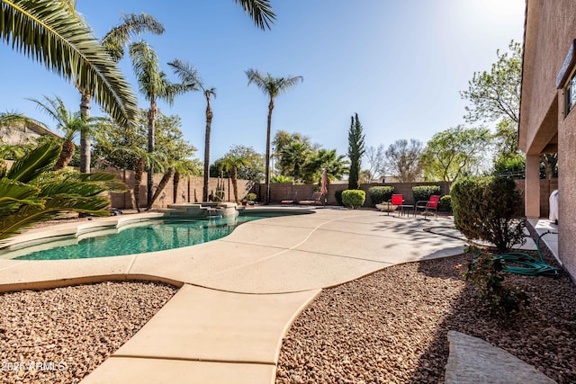 view of pool with a patio area, a fenced backyard, and a pool with connected hot tub