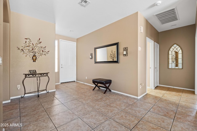 foyer with visible vents, baseboards, and light tile patterned flooring