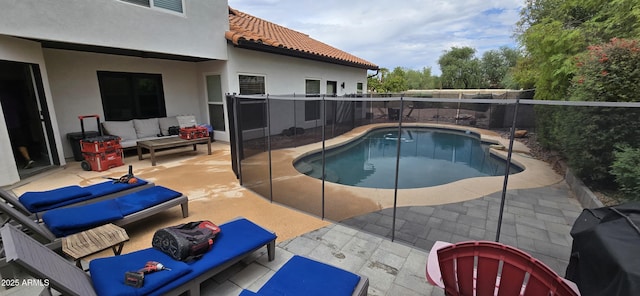view of swimming pool with a fenced backyard, a fenced in pool, an outdoor living space, and a patio area