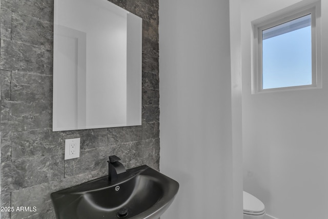 475 W Saddle Mountain Rd, Phoenix, AZ 85086 - half bathroom with a sink, toilet, and backsplash