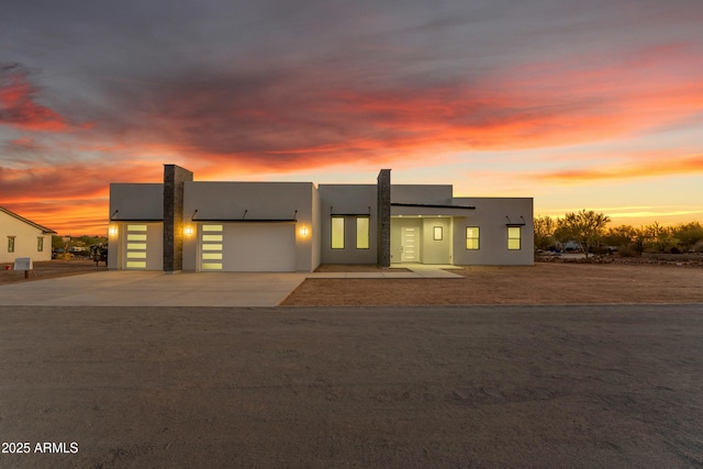 475 W Saddle Mountain Rd, Phoenix, AZ 85086 - modern home with stucco siding, a garage, concrete driveway, and solar panels
