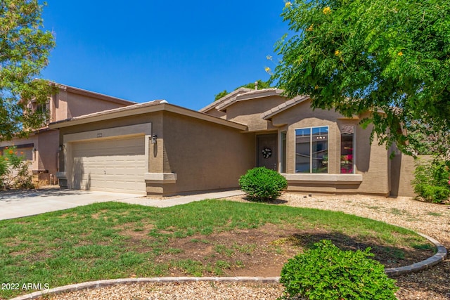 view of front of home featuring an attached garage, driveway, and stucco siding