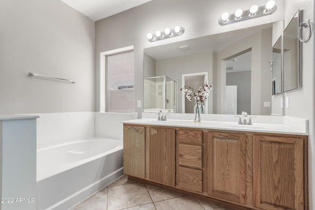 bathroom with double vanity, tile patterned floors, a sink, a shower stall, and a bath