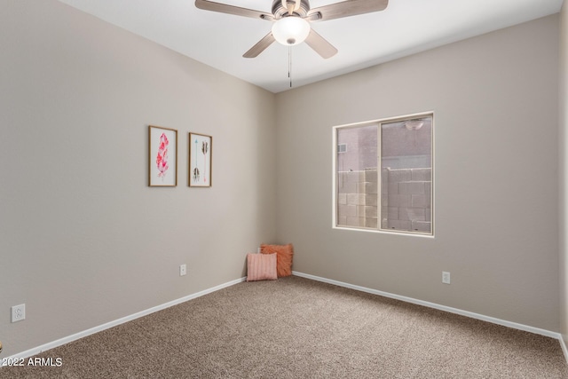 unfurnished room featuring carpet flooring, ceiling fan, and baseboards