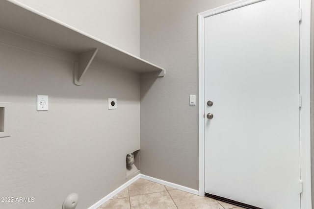 clothes washing area with light tile patterned floors, hookup for an electric dryer, laundry area, washer hookup, and baseboards