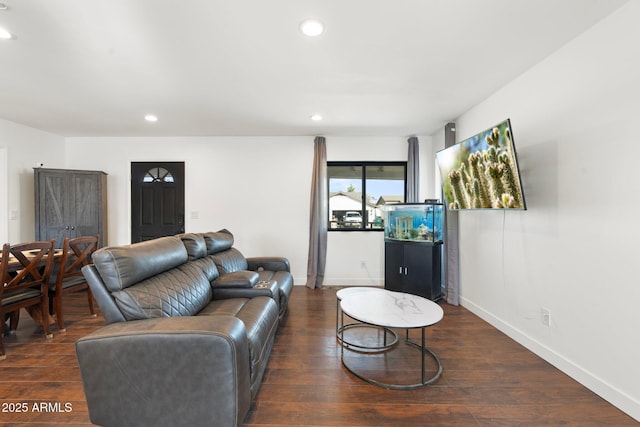 living room featuring dark wood-style flooring, baseboards, and recessed lighting