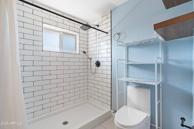 bathroom with a stall shower and toilet
