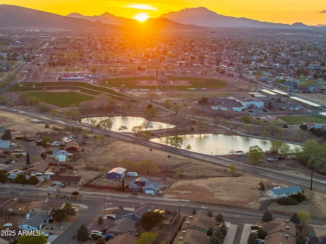 birds eye view of property featuring a water and mountain view