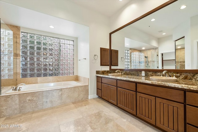 bathroom with independent shower and bath and vanity