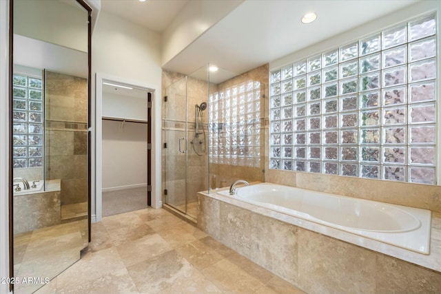 bathroom featuring shower with separate bathtub