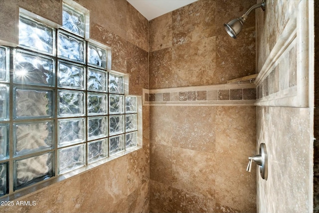 bathroom with a tile shower