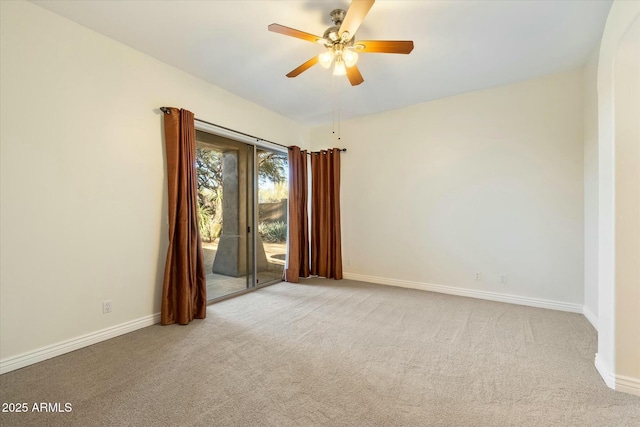 carpeted empty room featuring ceiling fan