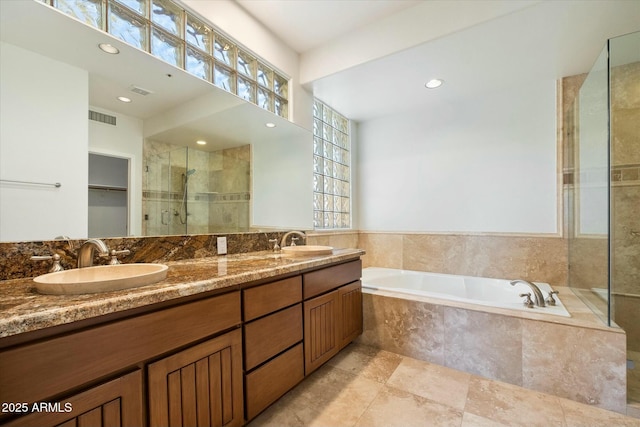 bathroom featuring separate shower and tub and vanity