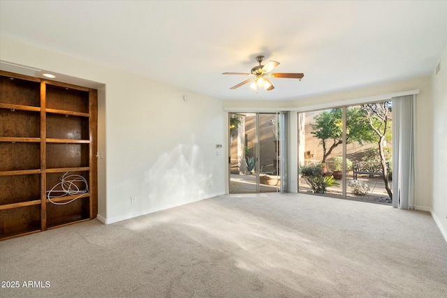 spare room featuring carpet floors and ceiling fan