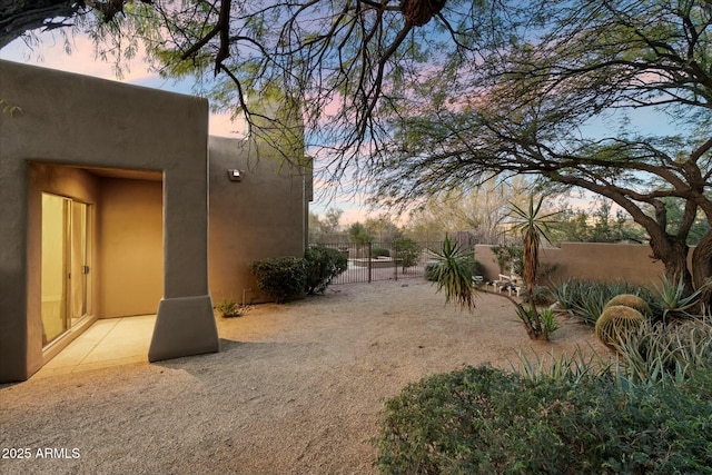 yard at dusk with a patio area