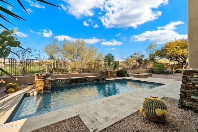 view of pool featuring pool water feature, a patio area, and a jacuzzi