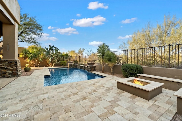 view of swimming pool featuring a fire pit, pool water feature, and a patio area