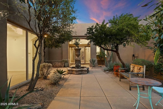 view of patio terrace at dusk