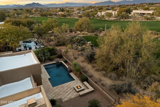 aerial view at dusk featuring a mountain view