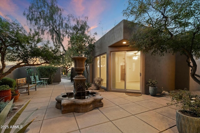 view of patio terrace at dusk