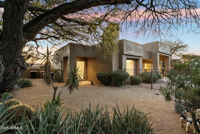 view of back house at dusk