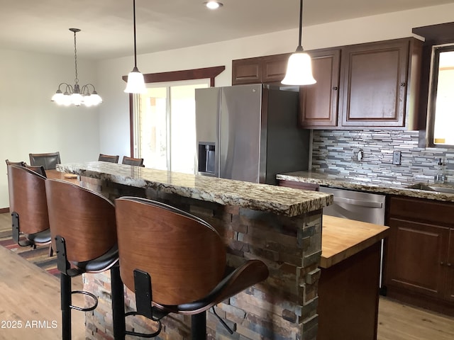 3607 E Mule Deer Rd, Pearce, AZ 85625 - kitchen featuring stainless steel appliances, wooden counters, plenty of natural light, a kitchen breakfast bar, and recessed lighting