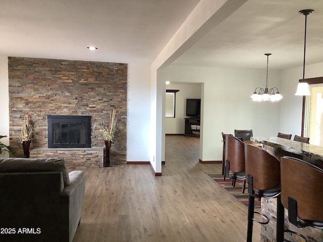 3607 E Mule Deer Rd, Pearce, AZ 85625 - living room featuring wood finished floors, baseboards, and a stone fireplace