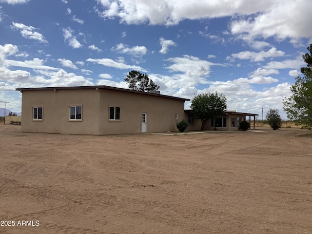 3607 E Mule Deer Rd, Pearce, AZ 85625 - rear view of house featuring stucco siding and a carport