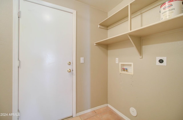 laundry area featuring light tile patterned floors, hookup for a washing machine, hookup for an electric dryer, laundry area, and baseboards