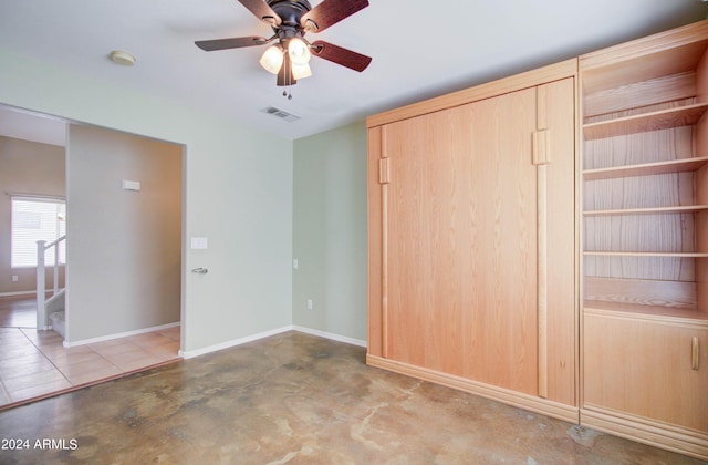 unfurnished bedroom featuring concrete flooring, visible vents, ceiling fan, and baseboards