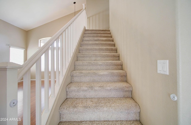 staircase featuring wood finished floors