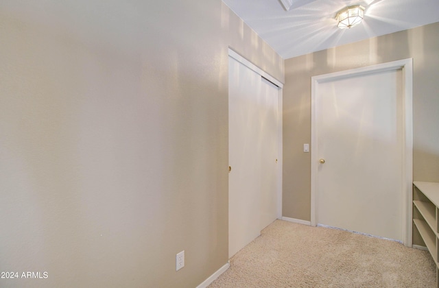 hallway featuring light carpet