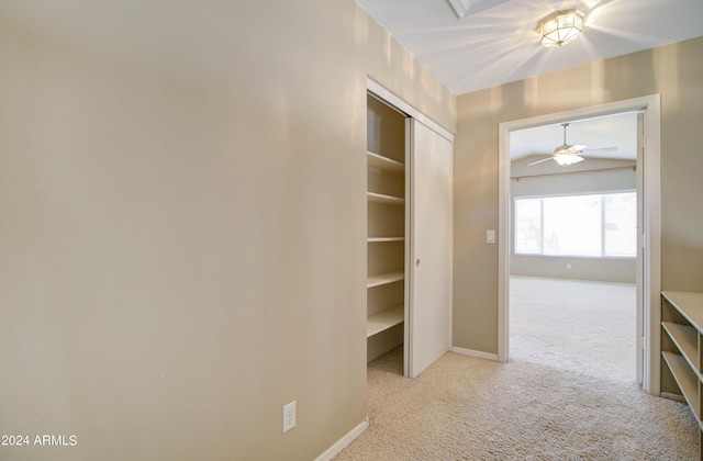 hall with light carpet and baseboards