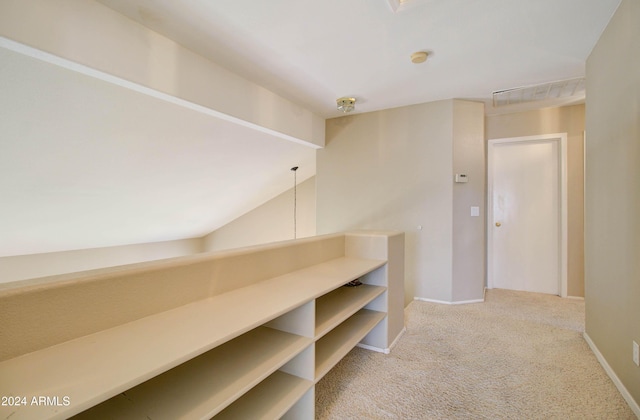 hallway featuring carpet floors and baseboards