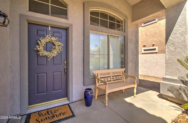 doorway to property with stucco siding